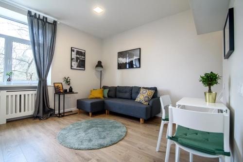 a living room with a couch and a table at Modern 1BR / Near Gates of Dawn / Special Offer in Vilnius