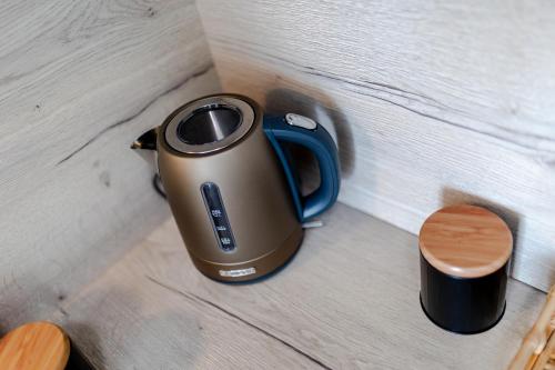a teapot sitting on top of a wooden table at LelleMarine by BLTN Apartmanok Balatonlelle in Balatonlelle