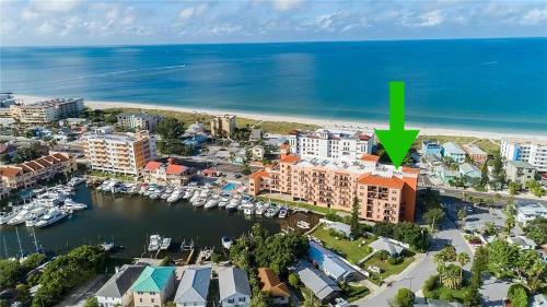 an aerial view of a resort with a green arrow at Gulf Coast Gold Private Condo - 2bed, 2bath, Sleep 6, Across Street from Beach, Balcony Views Of Sunsets, Beach & Gulf, Pool, Gym in St Pete Beach