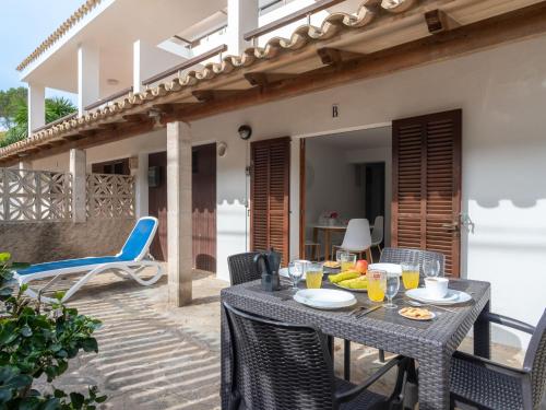 a table and chairs on the patio of a house at Apartment Clara B - CSV177 by Interhome in Cala de Sant Vicenc
