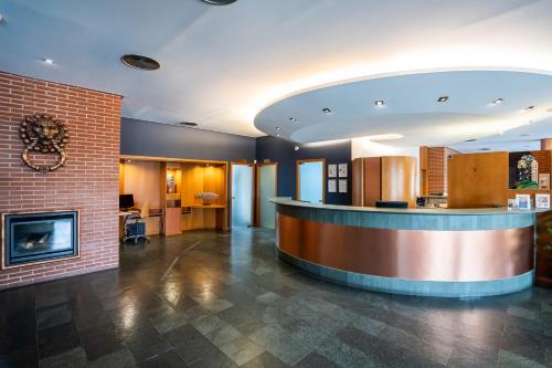 a lobby with a counter and a fireplace at Posadas de España Pinto in Pinto