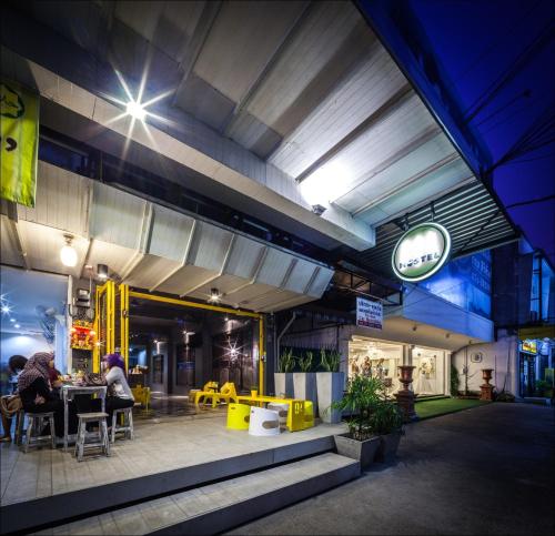 a restaurant with people sitting at a table in a building at Fulfill Phuket - SHA in Phuket