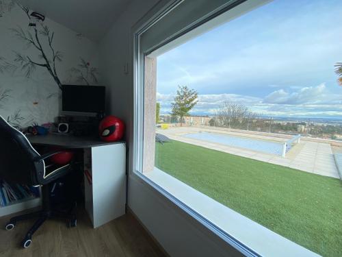a window in a room with a desk and a computer at Villa 6 chambres avec piscine et vue exceptionnelle in Saint-Genis-Laval