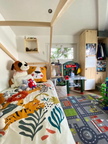 a childs bedroom with a bed with animals on it at Villa 6 chambres avec piscine et vue exceptionnelle in Saint-Genis-Laval