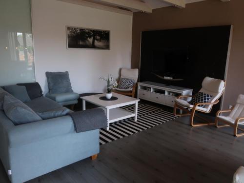 a living room with a couch and a flat screen tv at Holiday Home Sternenhimmel by Interhome in Schwanau