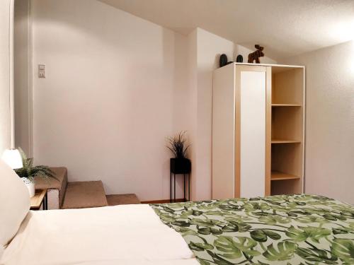 a bedroom with a bed and a book shelf at Holiday Home Sternenhimmel by Interhome in Schwanau
