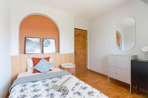 a bedroom with a bed with an arch above it at Modern Style Townhome /2BR near CNX moat in Chiang Mai
