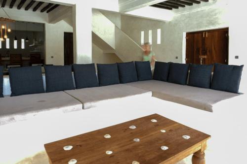 a living room with a couch and a table at Milimani Villa-Fully airconditioned Villa in Shela