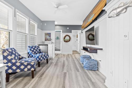 a living room with two chairs and a table at Genuine Holden Beach Ocean front with private pool and great beach views in Holden Beach