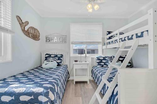a bedroom with two beds and a bunk bed at I'll Be There For You in Ocean Isle Beach