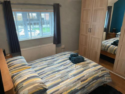 a bedroom with a bed with a stuffed animal on it at Beautiful 3-Bed House in Romford in Romford