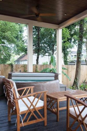 a porch with a table and chairs and a piano at Secret Garden Studio w/ Hot Tub: Near Forsyth Park in Savannah