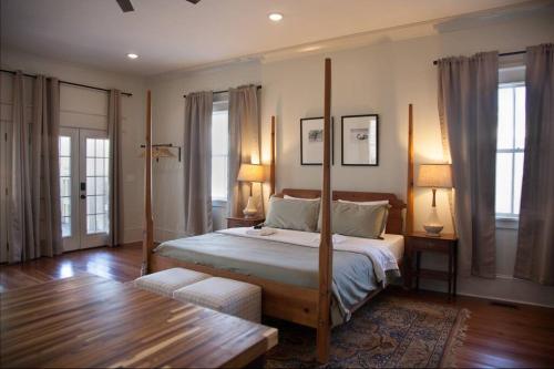 a bedroom with a bed with a four post bed frame at Secret Garden Studio w/ Hot Tub: Near Forsyth Park in Savannah