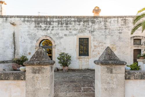 an old building with a gate in front of it at Masseria Brigantino in Torre Canne