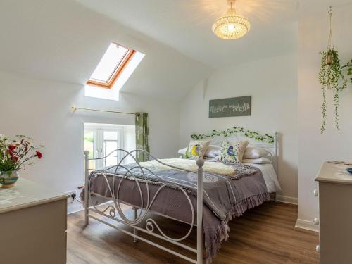 a bedroom with a bed and a skylight at 3 Bed in South Molton 78304 in Kings Nympton