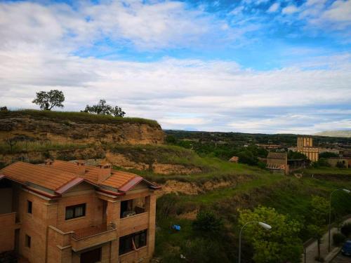 a building sitting on top of a green hill at 2 bedrooms apartement with wifi at Barbastro in Barbastro