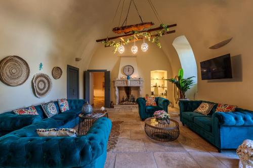 a living room with blue couches and a fireplace at Masseria Brigantino in Torre Canne