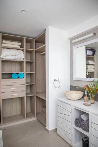 a bathroom with a walk in closet with a mirror at Entire Appartment - Pereybere, Grand Baie in Bain Boeuf