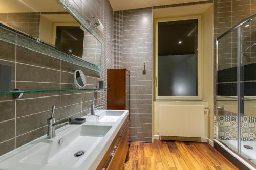 un bagno con due lavandini e una doccia di KasaLilou, Grand Gîte de prestige St Lary a Vignec