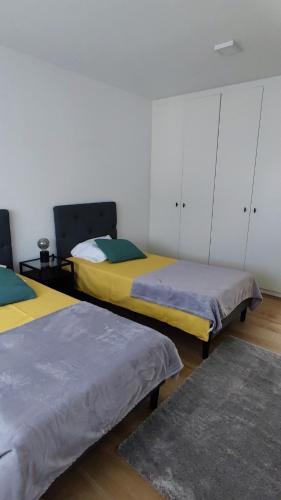 a room with two beds in a room at feel... Azores - apartments in Velas