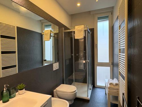 a bathroom with a shower and a toilet and a sink at AwesHomeItaly - The Little Beauty Studio in Pisa