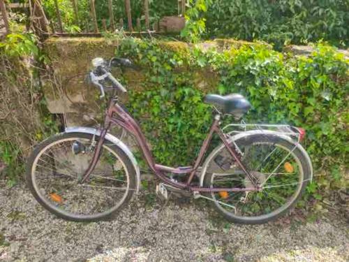 a bike is parked next to a wall at Maison accueillante à Bléré avec cheminée et terrasse in Bléré
