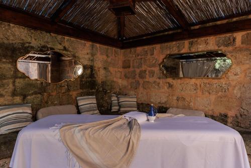 a dining room with two tables and chairs with a blanket on them at Masseria Brigantino in Torre Canne
