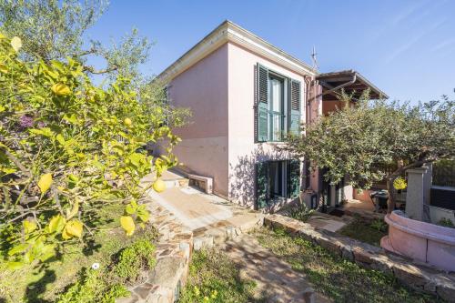 a house with trees in front of it at Cara House in Àrbatax