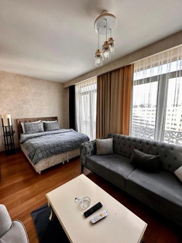 a living room with a couch and a bed at SABİHA GOKCEN İSTANBUL HOUSES Airport in Istanbul