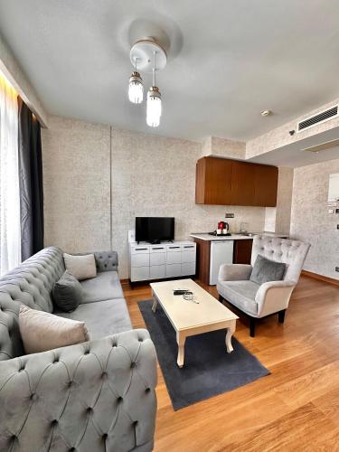 a living room with a couch and a table at SABİHA GOKCEN İSTANBUL HOUSES Airport in Istanbul