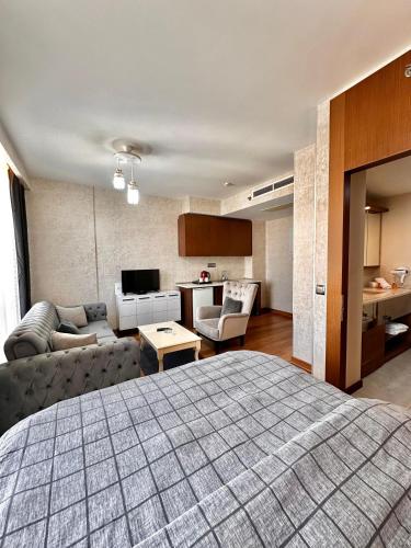a bedroom with a bed and a living room at SABİHA GOKCEN İSTANBUL HOUSES Airport in Istanbul