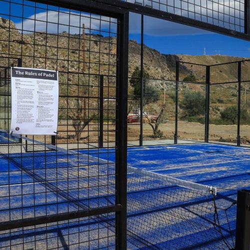 a cage in a building with a sign on it at Kamari Beach in Lardos