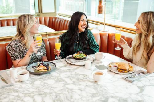 a group of women sitting around a table with drinks at Fairmont Pittsburgh in Pittsburgh