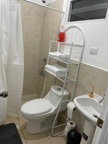 a bathroom with a toilet and a sink at Santa ana casa in Santa Ana