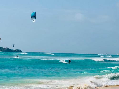 a group of people riding the waves in the ocean at Ocean Breeze 9 in Sal Rei