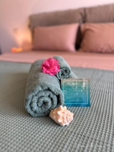 a stuffed animal with a flower on its head on a bed at Ocean Breeze 9 in Sal Rei