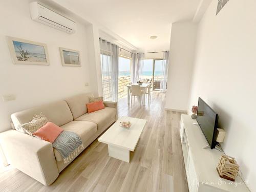 a living room with a couch and a tv at Ocean Breeze 9 in Sal Rei