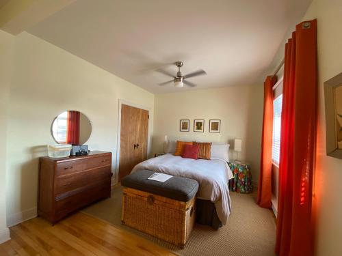 a bedroom with a bed and a wooden dresser and a bed sidx sidx sidx at Les 3 Chambres in Montreal