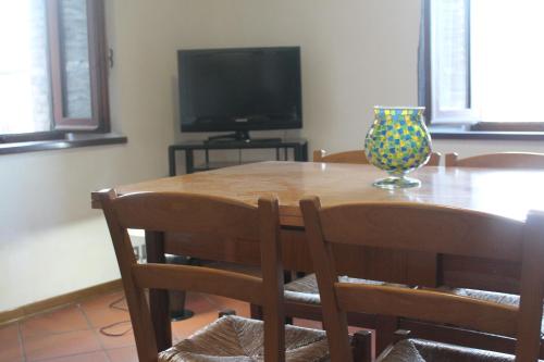 a dining room table with a vase on top of it at La Torre di Melezzole in Melezzole