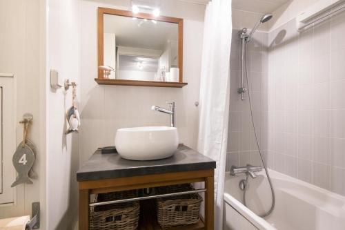 uma casa de banho com um lavatório, um chuveiro e uma banheira em Les Mouettes Appartement cosy avec piscine em Saint-Martin-de-Ré
