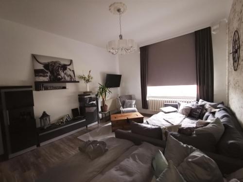 a living room with a couch and a table at Pension Zur Alten Post in Havelberg