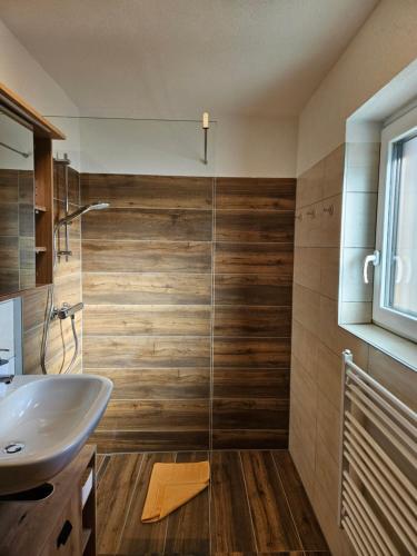 a bathroom with a sink and a shower at Ferienhaus Wiederschwing 