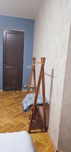 a ladder in a room with a wall and a door at Memory basket in Kutaisi