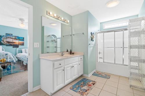 a bathroom with a sink and a mirror at Rip Tide I Brunswick Vacation Rentals in Sunset Beach
