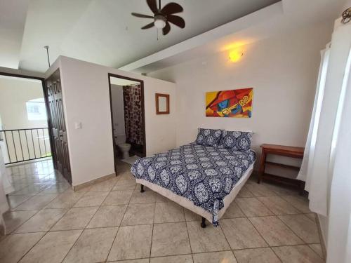 a bedroom with a bed and a ceiling fan at Golf and Ocean View Resort Home in San Diego