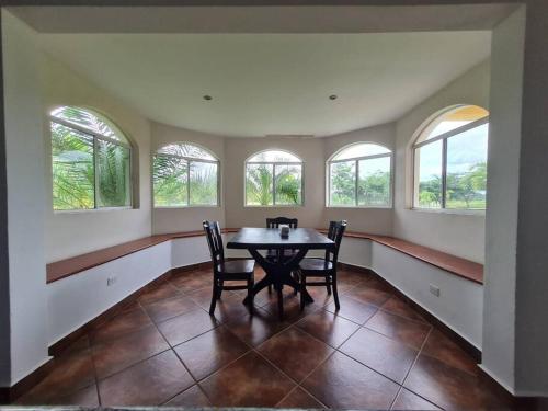 a dining room with a table and four windows at Golf and Ocean View Resort Home in San Diego