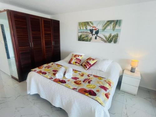 a bedroom with a bed with a white bedspread at French ocean view, beach and pool in Cul de Sac