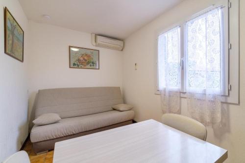 a living room with a couch and a table at Bourgarel in Vidauban