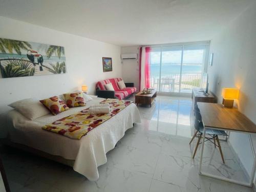 a bedroom with a bed and a living room at French ocean view, beach and pool in Cul de Sac