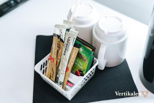 a container of toothbrushes and other items on a table at Vertikalen in Lillesand